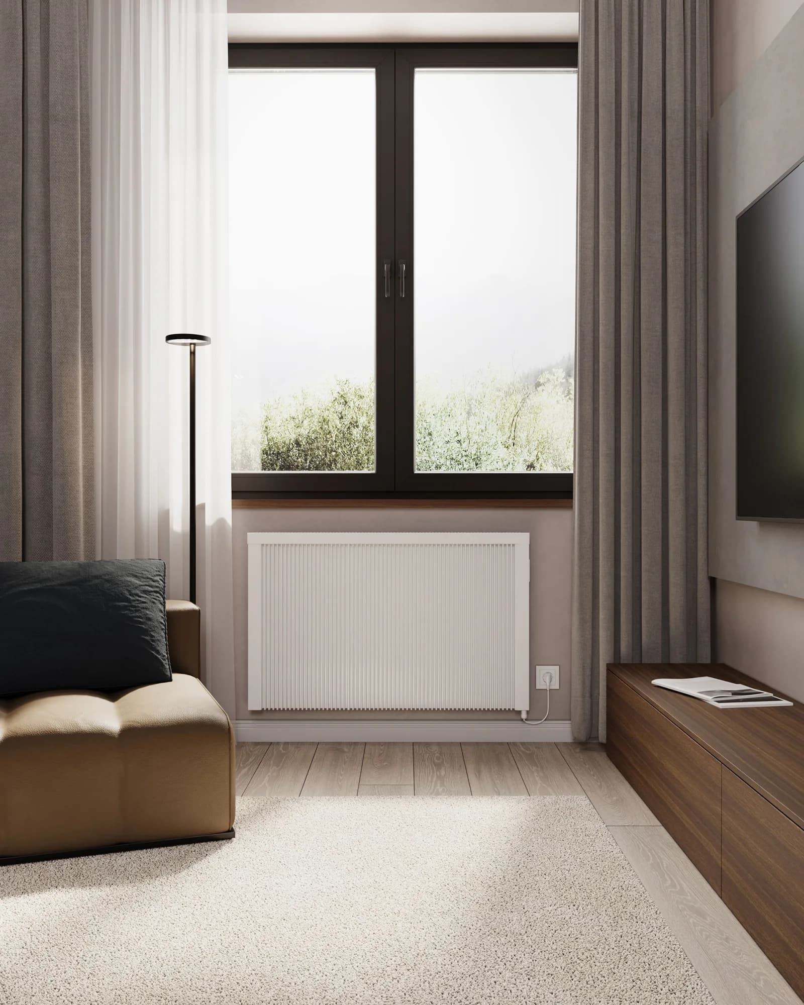 White radTherm electric radiator installed beneath a window in a bright living room